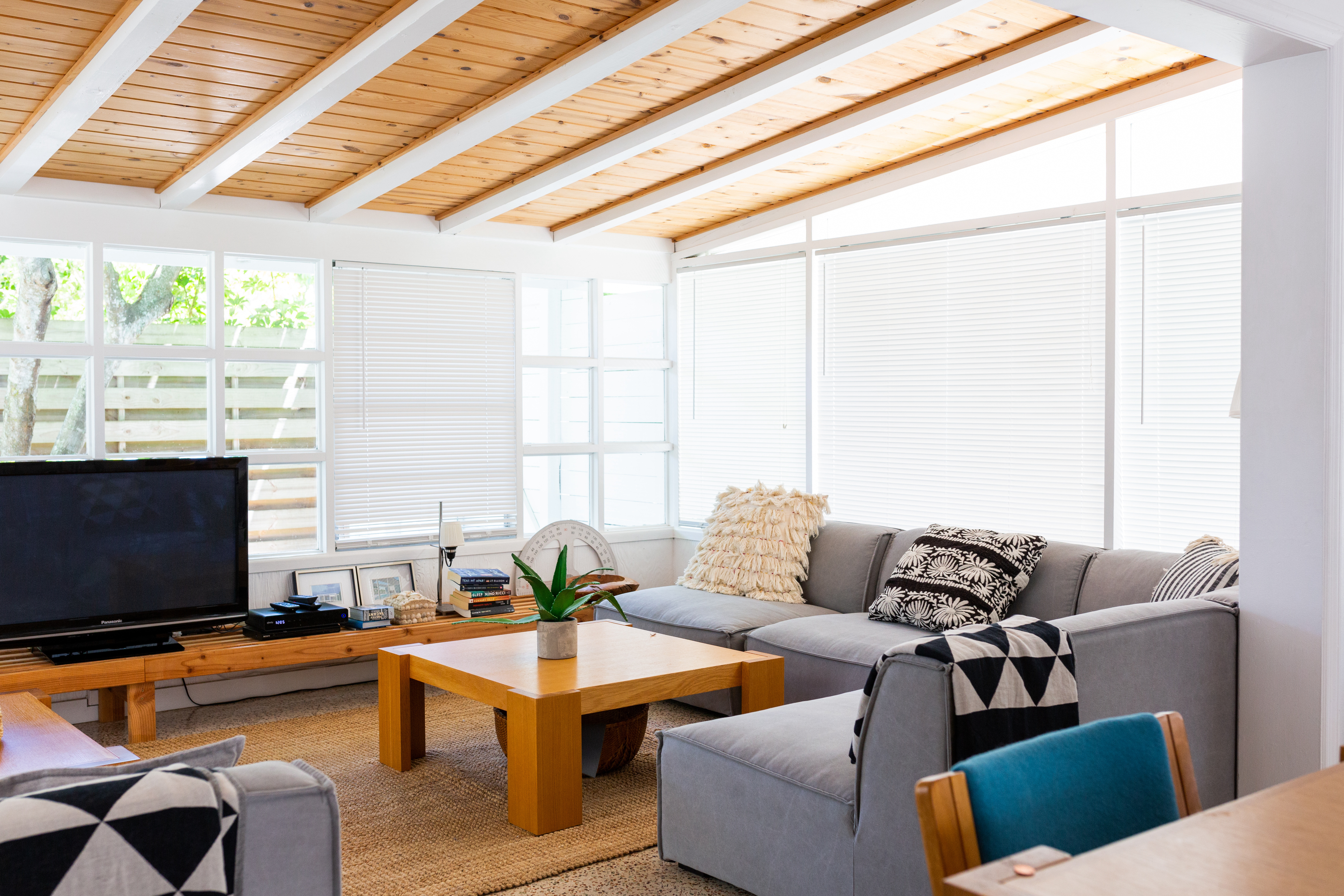 Mid century modern living room with a shiplap ceiling with beams